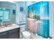 Charming bathroom with granite vanity, and a beach themed shower curtain at 363 Bella Cortina Dr, Kissimmee, FL 34759