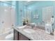 Bathroom with a granite-topped vanity, tiled shower and tub, and decorative accents at 363 Bella Cortina Dr, Kissimmee, FL 34759