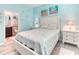 Bright bedroom with light blue walls, white furniture, starfish decor and an en-suite bathroom at 363 Bella Cortina Dr, Kissimmee, FL 34759