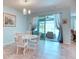 Bright dining area featuring a modern chandelier, patio access, and neutral color palette at 363 Bella Cortina Dr, Kissimmee, FL 34759