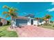 Charming single-story home featuring a two-car garage, brick driveway, and manicured lawn at 363 Bella Cortina Dr, Kissimmee, FL 34759