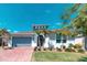 Charming single-story home with well-maintained landscaping, brick driveway and attached two-car garage at 363 Bella Cortina Dr, Kissimmee, FL 34759