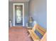 Charming front porch with decorative door, potted plants, bench and brick flooring at 363 Bella Cortina Dr, Kissimmee, FL 34759