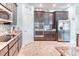 Spacious kitchen boasts dark wood cabinets, granite counters, and stainless steel appliances at 363 Bella Cortina Dr, Kissimmee, FL 34759
