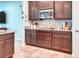 Well-equipped kitchen with granite countertops, dark wood cabinetry, and tile flooring at 363 Bella Cortina Dr, Kissimmee, FL 34759