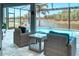 Screened lanai overlooking the pool and waterfront with cushioned seating at 363 Bella Cortina Dr, Kissimmee, FL 34759