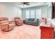 Inviting living room with plantation shutters, comfortable seating, ceiling fan and entertainment center at 363 Bella Cortina Dr, Kissimmee, FL 34759