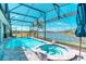 Screened-in pool and hot tub overlooking lake and manicured grounds creating a serene outdoor experience at 363 Bella Cortina Dr, Kissimmee, FL 34759