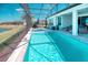 Enclosed pool and hot tub with waterfront views from the patio at 363 Bella Cortina Dr, Kissimmee, FL 34759