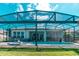 An inviting screened pool with a spa and an outdoor dining area at 363 Bella Cortina Dr, Kissimmee, FL 34759