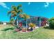 Screened pool with well-maintained lawn, lush tropical plants and palms at 363 Bella Cortina Dr, Kissimmee, FL 34759