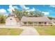 Charming single-story home with a covered front porch and a two-car detached garage at 7938 Riffle Ln, Orlando, FL 32818