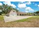 Charming single-story home with two-car garage and a spacious driveway under a sunny sky at 7938 Riffle Ln, Orlando, FL 32818