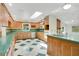 Bright eat-in kitchen with wood cabinets, skylight, updated appliances, and decorative accents at 7938 Riffle Ln, Orlando, FL 32818