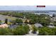 An aerial shot featuring a single-Gathering home shaded by trees, with a nearby lake enhancing its tranquil setting at 9509 Baycliff Ct, Orlando, FL 32836