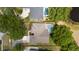 Aerial view of a residence featuring a private pool in a fenced yard, surrounded by mature trees at 9509 Baycliff Ct, Orlando, FL 32836