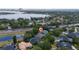 Expansive aerial view of a residential area featuring lush greenery and a tranquil lake, showcasing community charm at 9509 Baycliff Ct, Orlando, FL 32836