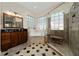 An open and airy bathroom with granite countertops, glass block windows, a shower, and a soaking tub at 9509 Baycliff Ct, Orlando, FL 32836