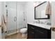 Bathroom featuring a glass enclosed shower, tile flooring, and a black vanity with marble top at 9509 Baycliff Ct, Orlando, FL 32836