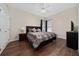 A well lit bedroom featuring hardwood floors, a ceiling fan, and neutral colored walls at 9509 Baycliff Ct, Orlando, FL 32836