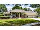 Beautiful single-story home boasts a well-manicured lawn, professional landscaping and a three-car garage at 9509 Baycliff Ct, Orlando, FL 32836