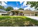 Charming single-story house featuring a three-car garage and well-maintained landscaping for curb appeal at 9509 Baycliff Ct, Orlando, FL 32836
