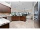 Open kitchen boasts wood cabinets, granite countertops and stainless steel appliances at 9509 Baycliff Ct, Orlando, FL 32836