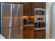 Modern kitchen boasts stainless steel appliances and wood cabinets at 9509 Baycliff Ct, Orlando, FL 32836