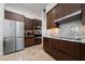 Contemporary kitchen featuring stainless steel appliances, wood cabinets, and granite counters at 9509 Baycliff Ct, Orlando, FL 32836