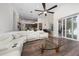 Spacious living room with hardwood floors, a large sectional sofa and views to the kitchen and lanai at 9509 Baycliff Ct, Orlando, FL 32836