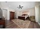 Main bedroom featuring hardwood floors, a sitting area, and a large bed at 9509 Baycliff Ct, Orlando, FL 32836