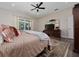 Spacious main bedroom suite with king bed, wood floors, and view of the backyard pool at 9509 Baycliff Ct, Orlando, FL 32836