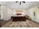 Spacious main bedroom with wood floors, a king bed, and access to a private patio at 9509 Baycliff Ct, Orlando, FL 32836