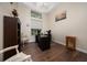 Bright office featuring hardwood floors, a black desk, and a window with a view at 9509 Baycliff Ct, Orlando, FL 32836