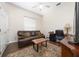 Office with brown leather sofa, accent rug, and hardwood floors at 9509 Baycliff Ct, Orlando, FL 32836