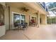Covered patio with ceiling fans, outdoor seating and cooking area provides relaxation and entertainment space at 9509 Baycliff Ct, Orlando, FL 32836
