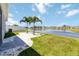 Scenic backyard with a gorgeous lake view, palm trees, a stone paver pathway and well-maintained lawn at 1180 Lone Palm Way, St Cloud, FL 34771