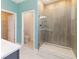 A modern bathroom featuring a glass-enclosed shower and access to a walk-in closet at 1180 Lone Palm Way, St Cloud, FL 34771