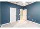 Bedroom features a ceiling fan and door leading to a hallway at 1180 Lone Palm Way, St Cloud, FL 34771