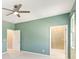 The main bedroom includes an ensuite bathroom and a ceiling fan at 1180 Lone Palm Way, St Cloud, FL 34771