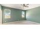 Spacious bedroom with two windows overlooking a tranquil pond and neighboring houses at 1180 Lone Palm Way, St Cloud, FL 34771