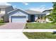 Charming single-Gathering home featuring a brick driveway and manicured front yard at 1180 Lone Palm Way, St Cloud, FL 34771