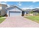 Inviting single-Gathering home boasting a two-car garage and landscaped front yard at 1180 Lone Palm Way, St Cloud, FL 34771