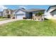 Well-maintained home with lush green lawn, and vibrant landscaping at 1180 Lone Palm Way, St Cloud, FL 34771