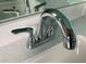 Close up of a chrome bathroom faucet and quartz countertop at 1180 Lone Palm Way, St Cloud, FL 34771