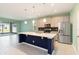 Modern kitchen featuring a large island, stainless steel appliances and tile backsplash at 1180 Lone Palm Way, St Cloud, FL 34771