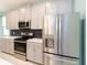 Stylish kitchen features stainless steel appliances and ample counter space at 1180 Lone Palm Way, St Cloud, FL 34771