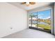Enclosed lanai with a view of the lake and community, with a decorative ceiling fan and bright neutral colors at 1180 Lone Palm Way, St Cloud, FL 34771