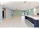 Open-concept living room featuring tile floors, neutral paint, and slider doors to lanai at 1180 Lone Palm Way, St Cloud, FL 34771