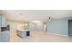 Spacious open floor plan with wood-look floors connecting the living room and kitchen area at 1180 Lone Palm Way, St Cloud, FL 34771
